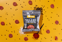 Load image into Gallery viewer, Buck 'n' Bird air-dried salami crisps in original flavor, packaged in a silver bag on a yellow background. Scattered salami slices, black peppercorns, and a spoonful of paprika surround the pack, highlighting the snack's rich taste and keto-friendly, gluten-free qualities.